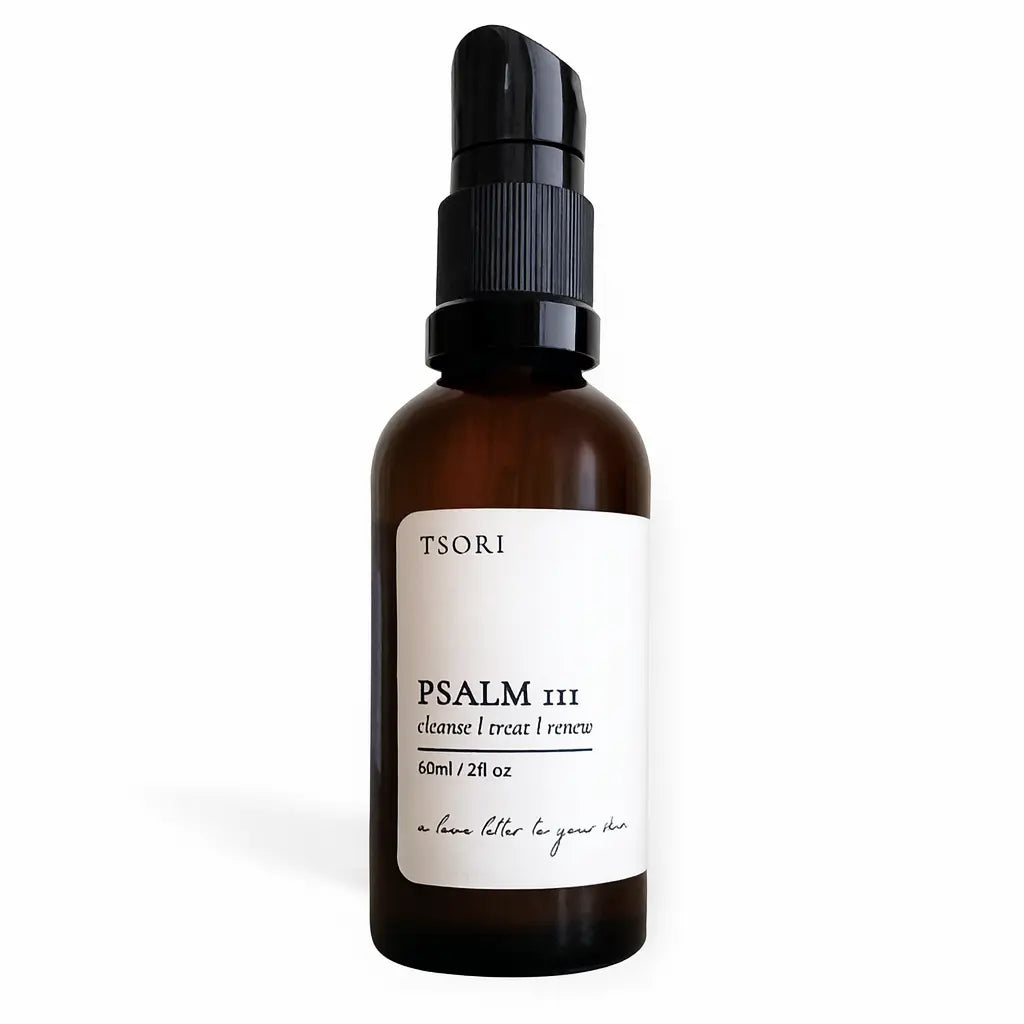 Brown bottle with black spray nozzle and white label on a white background