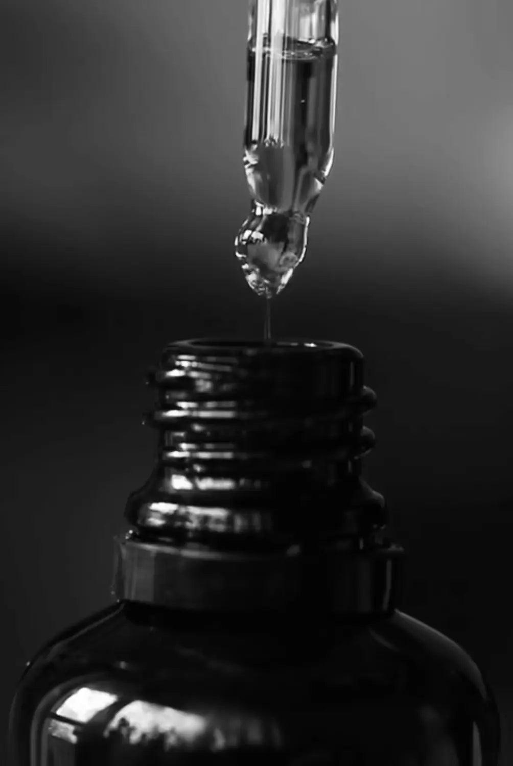 black and white image of oil pipette and bottle