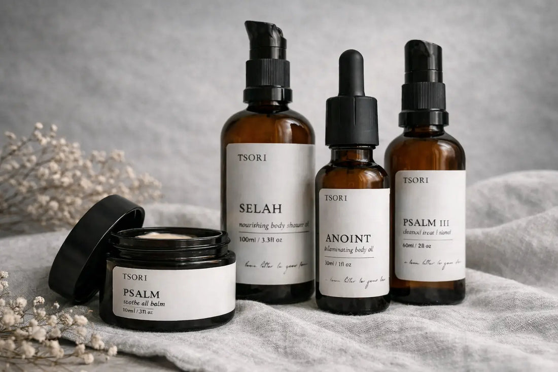 TSORI skincare collection displayed in amber glass bottles and a balm jar on neutral linen.