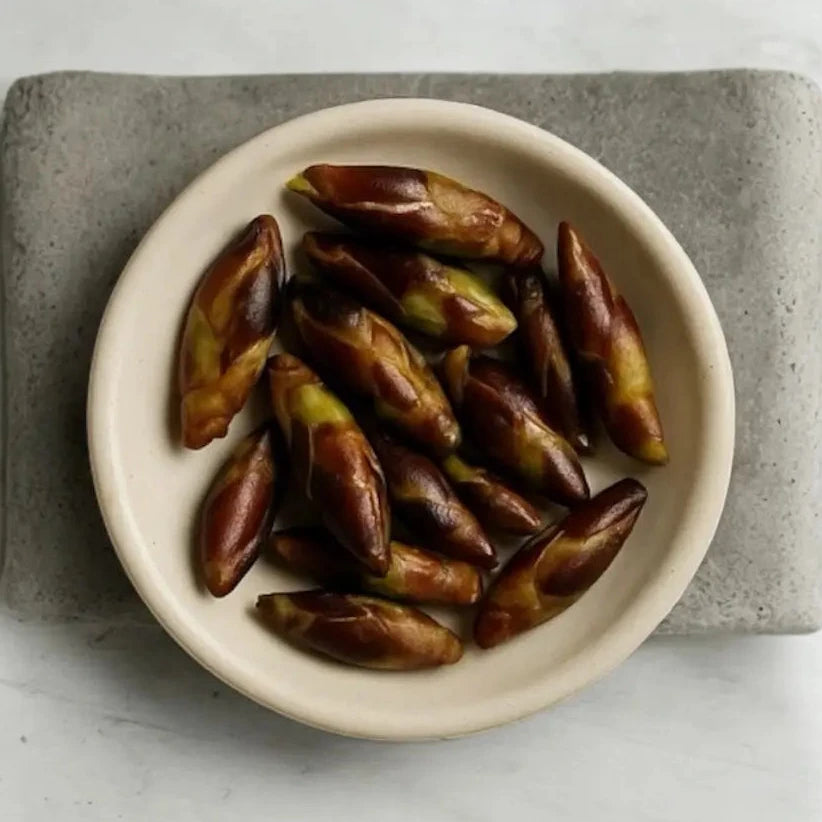 White bowl filled with dates on a gray stone surface