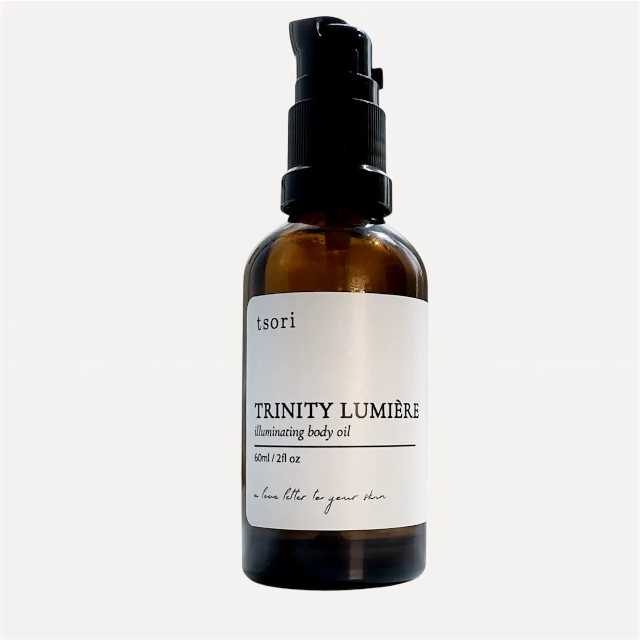 Brown bottle with black cap labeled 'tsori Trinity Lumérie' on a white background