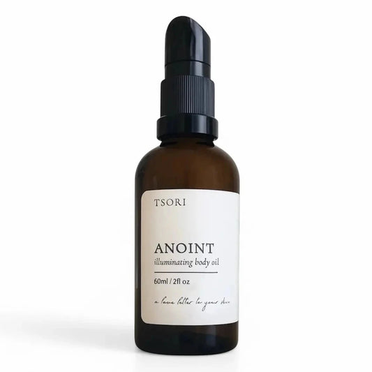 Brown glass bottle with black cap and white label on a white background